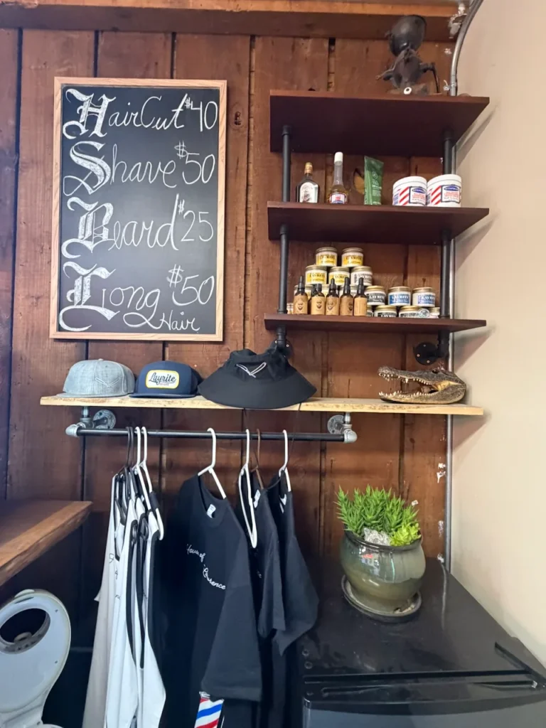 Hand-lettered price board listing haircut, shave and beard prices in Old Town San Diego